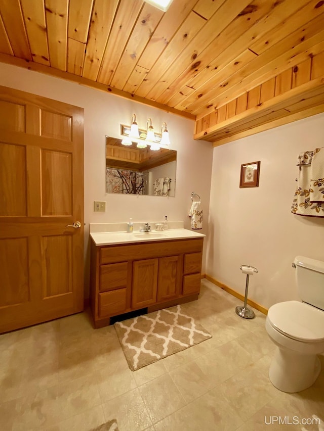 E1849 H44 Hwy, Trenary, MI 49891 - bathroom featuring vanity, toilet, wooden ceiling, and baseboards