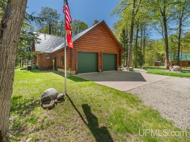 E1849 H44 Hwy, Trenary, MI 49891 - view of property exterior with log exterior, a garage, a yard, and driveway