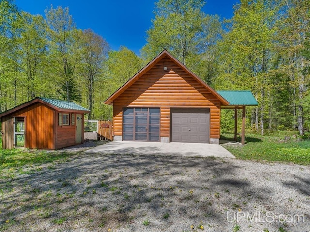 E1849 H44 Hwy, Trenary, MI 49891 - detached garage featuring gravel driveway and a view of trees