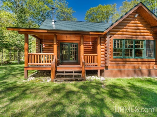 E1849 H44 Hwy, Trenary, MI 49891 - back of property with log siding, a lawn, french doors, and a wooden deck