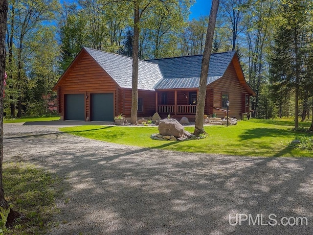 E1849 H44 Hwy, Trenary, MI 49891 - log home featuring covered porch, log siding, driveway, and a front yard