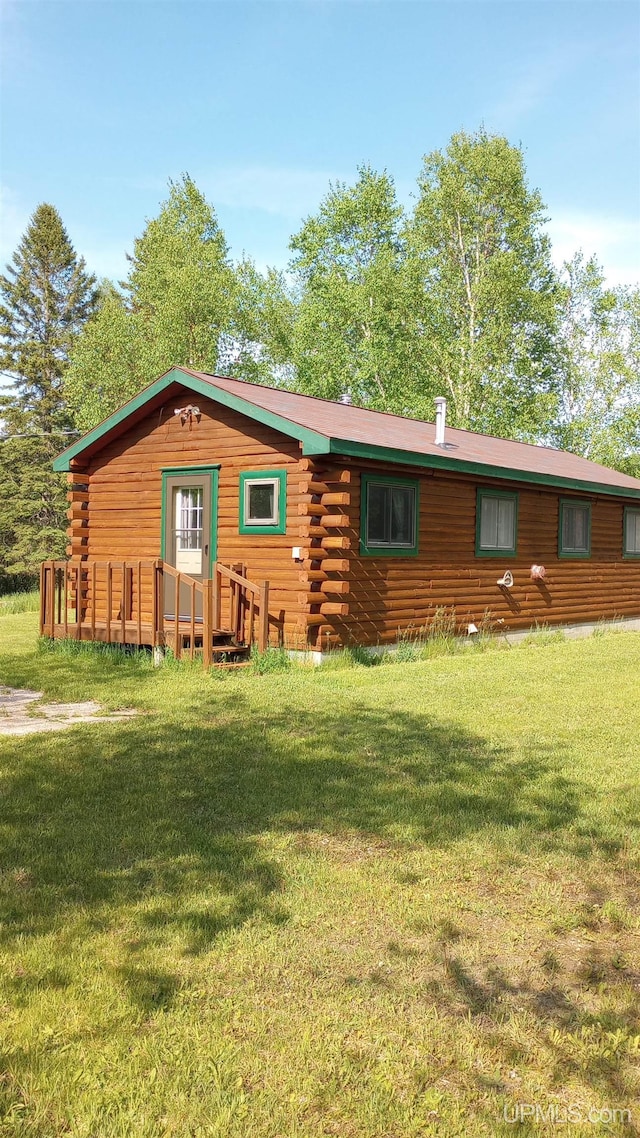 22252 E Webb Rd, Grand Marais, MI 49839 - view of front of property featuring log exterior and a front lawn