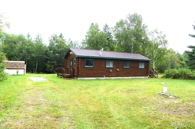 22252 E Webb Rd, Grand Marais, MI 49839 - back of property featuring log siding, a lawn, and a shed