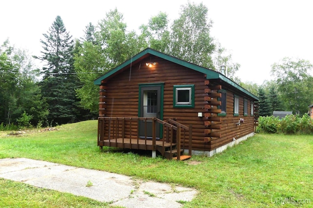 22252 E Webb Rd, Grand Marais, MI 49839 - view of home's exterior with log siding and a lawn