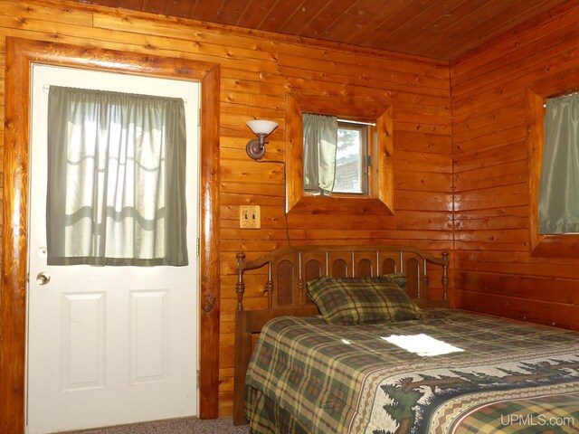 22252 E Webb Rd, Grand Marais, MI 49839 - carpeted bedroom featuring wood walls and wood ceiling