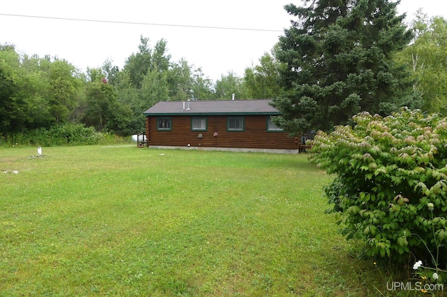 22252 E Webb Rd, Grand Marais, MI 49839 - back of property with a yard and log exterior
