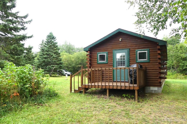 22252 E Webb Rd, Grand Marais, MI 49839 - back of house featuring log exterior, a wooden deck, and a yard