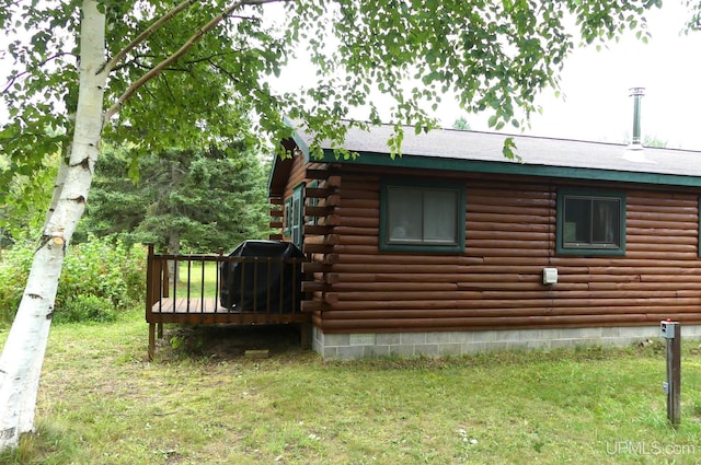22252 E Webb Rd, Grand Marais, MI 49839 - view of home's exterior featuring log exterior, a deck, and a yard
