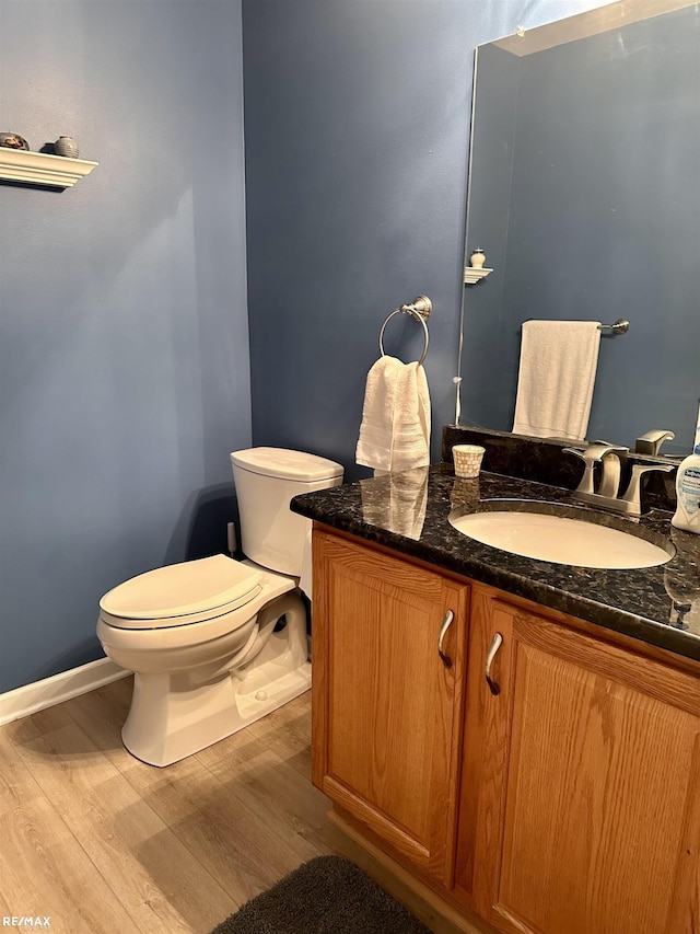 39148 Canterbury Dr, Harrison Twp, MI 48045 - bathroom featuring toilet, vanity, and wood finished floors