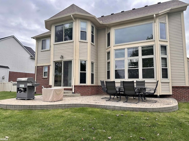 39148 Canterbury Dr, Harrison Twp, MI 48045 - back of property with brick siding, a patio, a lawn, and entry steps