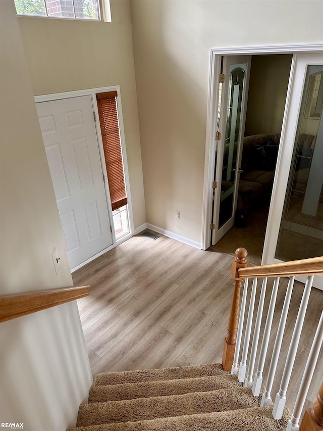 39148 Canterbury Dr, Harrison Twp, MI 48045 - entrance foyer with stairs, wood finished floors, baseboards, and a high ceiling