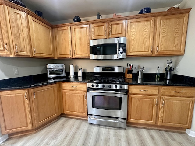 39148 Canterbury Dr, Harrison Twp, MI 48045 - kitchen featuring stainless steel appliances, light wood-style flooring, and dark stone counters