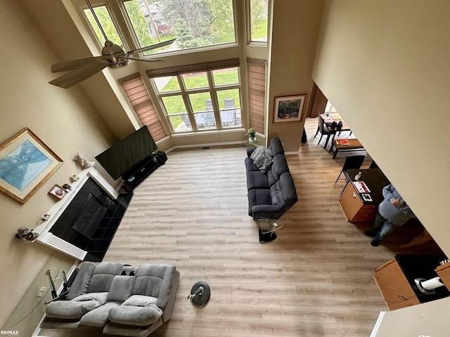 39148 Canterbury Dr, Harrison Twp, MI 48045 - living area with a high ceiling, a ceiling fan, wood finished floors, and baseboards
