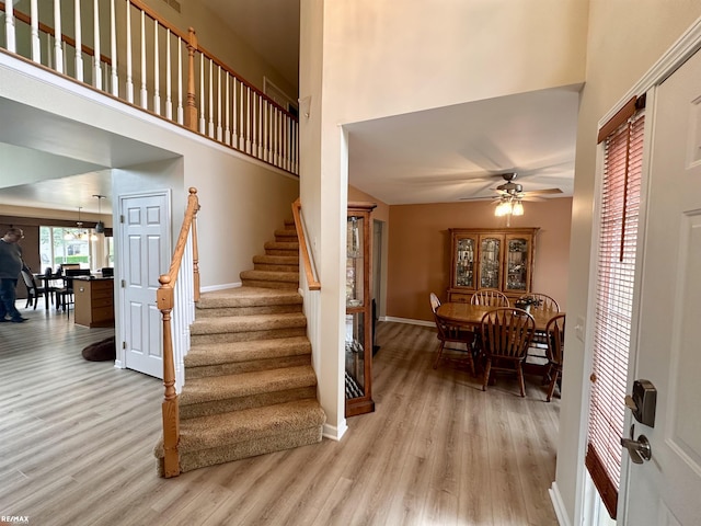39148 Canterbury Dr, Harrison Twp, MI 48045 - stairs featuring wood finished floors, baseboards, a high ceiling, and a ceiling fan