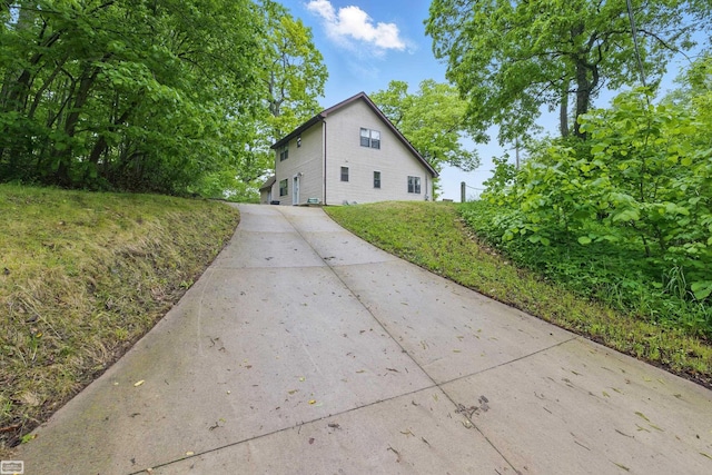 3620 Lakeshore Dr, Lapeer, MI 48446 - view of home's exterior featuring driveway and a lawn