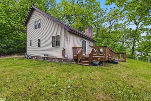 3620 Lakeshore Dr, Lapeer, MI 48446 - back of house with a chimney, a wooden deck, and a yard