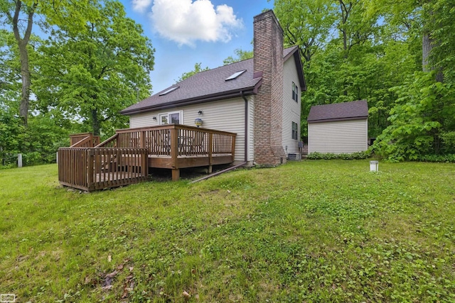 3620 Lakeshore Dr, Lapeer, MI 48446 - back of house with a deck, a yard, a chimney, roof with shingles, and an outdoor structure