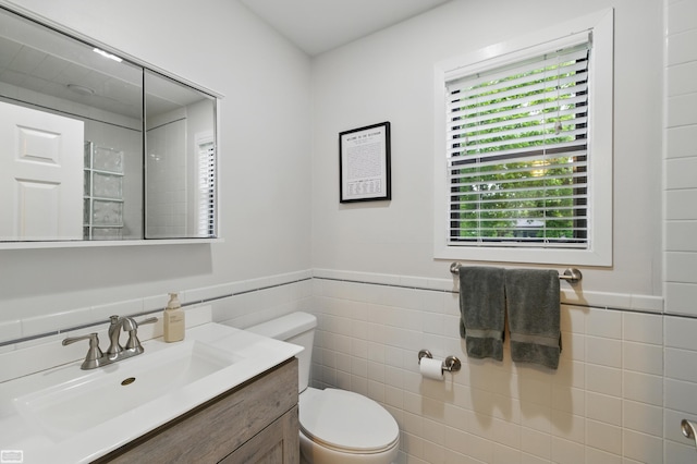 3620 Lakeshore Dr, Lapeer, MI 48446 - bathroom with vanity, toilet, tile walls, and a wainscoted wall