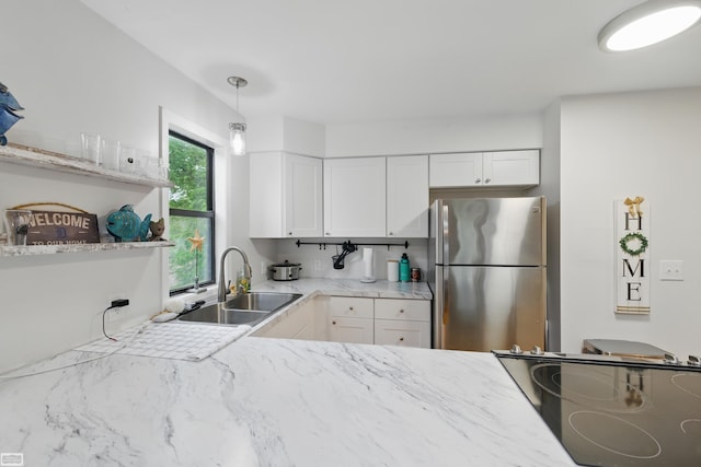 3620 Lakeshore Dr, Lapeer, MI 48446 - kitchen with freestanding refrigerator, a sink, white cabinetry, decorative light fixtures, and open shelves