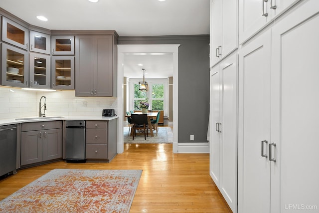624 E G St, Iron Mountain, MI 49801 - kitchen featuring a sink, gray cabinetry, dishwasher, decorative backsplash, and light wood-style floors