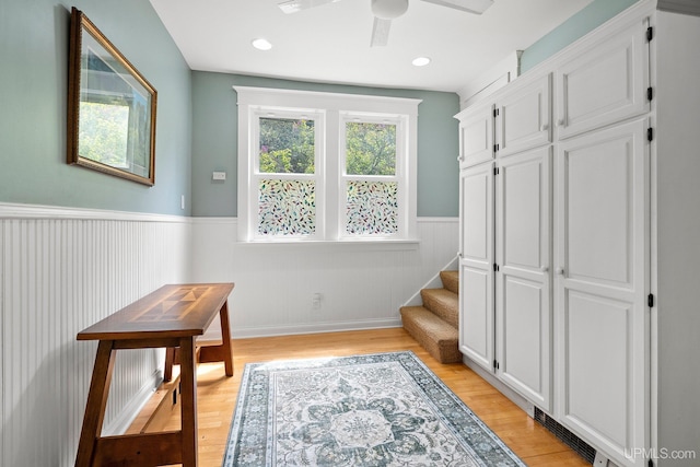 624 E G St, Iron Mountain, MI 49801 - interior space with a wainscoted wall, stairs, a ceiling fan, and light wood-type flooring