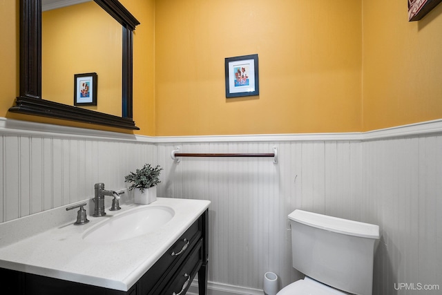 624 E G St, Iron Mountain, MI 49801 - half bath featuring wainscoting, toilet, and vanity