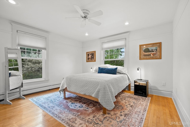 624 E G St, Iron Mountain, MI 49801 - bedroom with light wood-type flooring, recessed lighting, ceiling fan, baseboards, and a baseboard heating unit