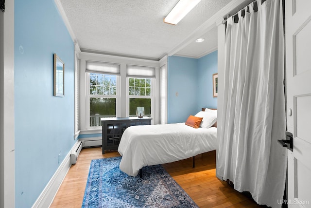 624 E G St, Iron Mountain, MI 49801 - bedroom with ornamental molding, a textured ceiling, wood finished floors, and baseboards