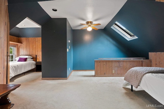 624 E G St, Iron Mountain, MI 49801 - bedroom featuring vaulted ceiling, a skylight, carpet, wooden walls, and a ceiling fan