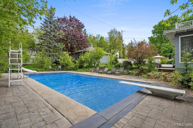 624 E G St, Iron Mountain, MI 49801 - swimming pool with a diving board, a water slide, and a patio area