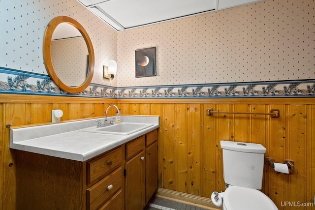 624 E G St, Iron Mountain, MI 49801 - bathroom featuring vanity, wallpapered walls, toilet, a wainscoted wall, and wood walls