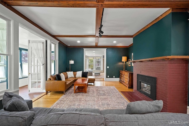 624 E G St, Iron Mountain, MI 49801 - living room featuring light wood finished floors, beamed ceiling, a brick fireplace, recessed lighting, and ornamental molding