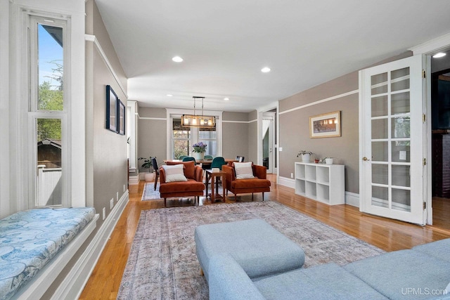 624 E G St, Iron Mountain, MI 49801 - living room featuring light wood-type flooring, baseboards, recessed lighting, and a chandelier
