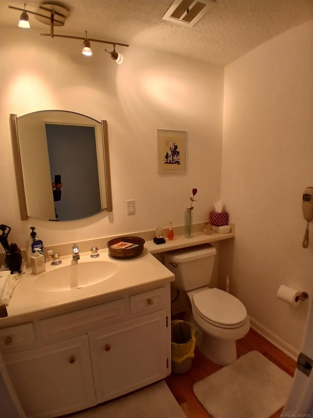 22460 La Von St, Saint Clair Shores, MI 48081 - bathroom with vanity, toilet, wood finished floors, and a textured ceiling