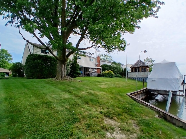 22460 La Von St, Saint Clair Shores, MI 48081 - view of green lawn with boat lift, a water view, and a dock