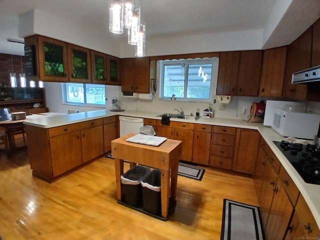 22460 La Von St, Saint Clair Shores, MI 48081 - kitchen featuring white appliances, a peninsula, light wood-style floors, light countertops, and a sink