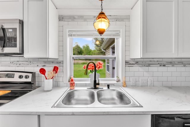 1371 Sturdevant St, Kimball, MI 48074 - kitchen with stainless steel appliances, a sink, decorative backsplash, and white cabinets