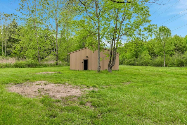 1371 Sturdevant St, Kimball, MI 48074 - view of grassy yard featuring an outdoor structure and a wooded view