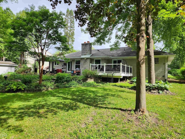 6038 Candler Dr, Shelby Twp, MI 48316 - back of property featuring a lawn, a chimney, and a wooden deck