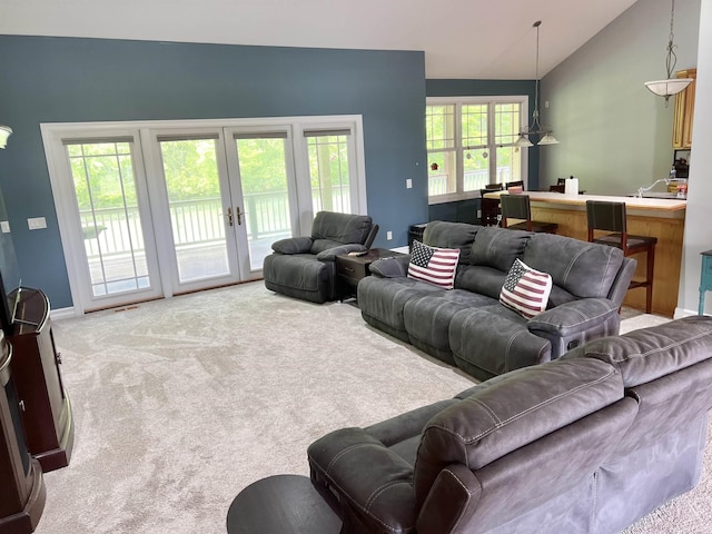 815 Cove Rd, Wales, MI 48027 - carpeted living area with french doors and vaulted ceiling