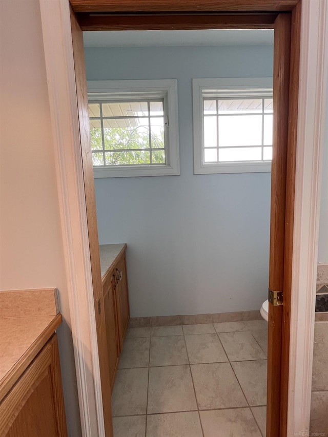 815 Cove Rd, Wales, MI 48027 - half bath featuring vanity, toilet, tile patterned floors, and baseboards