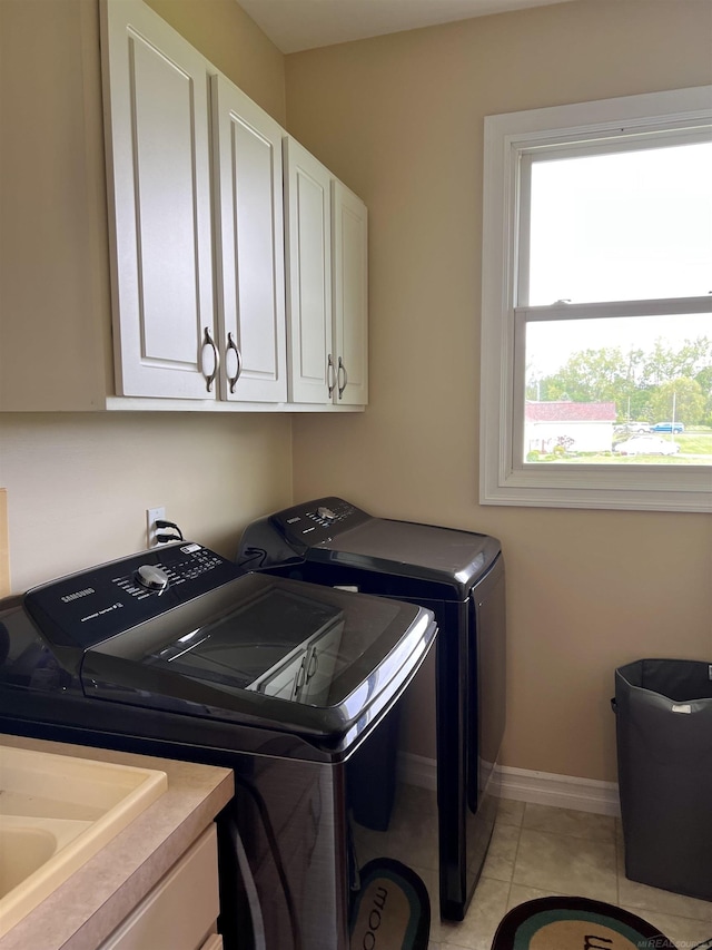 815 Cove Rd, Wales, MI 48027 - laundry room featuring cabinet space, washer and dryer, baseboards, and light tile patterned floors