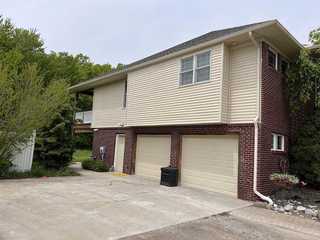 815 Cove Rd, Wales, MI 48027 - view of home's exterior featuring concrete driveway, a garage, and brick siding