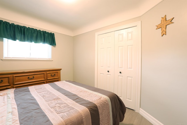 23300 Allor St, Saint Clair Shores, MI 48082 - bedroom featuring a closet, light wood finished floors, and baseboards