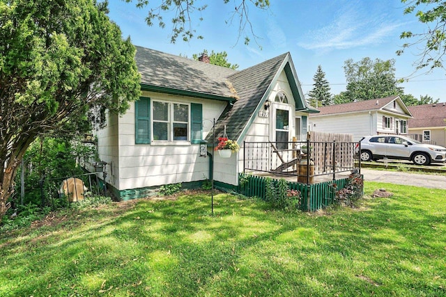 1471 James St, Burton, MI 48529 - view of front of property with roof with shingles, a front yard, and a chimney