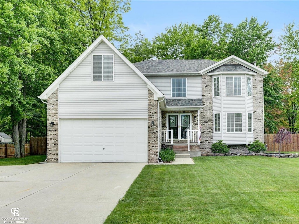 3185 Fanone Dr, Port Huron, MI 48060 - traditional-style house with driveway, brick siding, and an attached garage