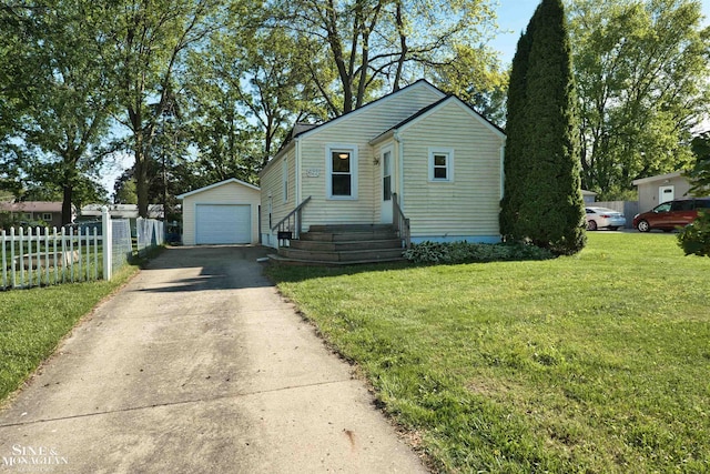 622 Kendon Dr, Lansing, MI 48910 - bungalow-style home with an outdoor structure, concrete driveway, and a detached garage