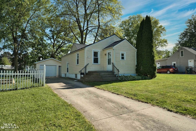 622 Kendon Dr, Lansing, MI 48910 - bungalow-style house with an outbuilding, a detached garage, driveway, and entry steps