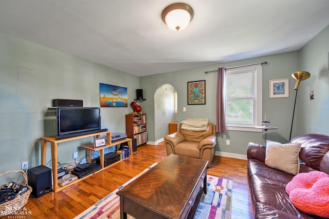 622 Kendon Dr, Lansing, MI 48910 - living area with arched walkways, hardwood / wood-style floors, and baseboards