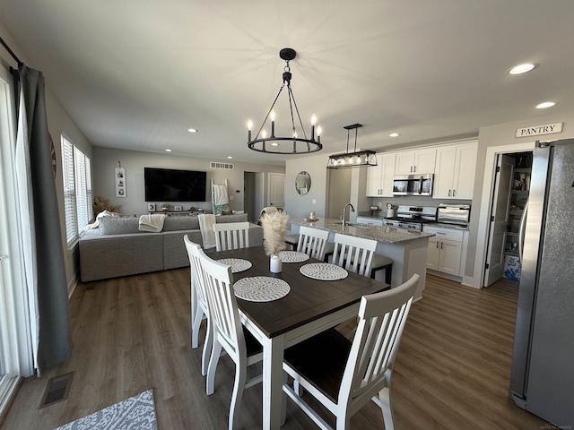 34317 Pratt Rd, Memphis, MI 48041 - dining area featuring recessed lighting, a chandelier, and dark wood-style flooring